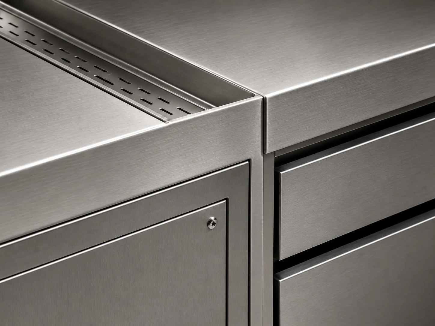 Precision stainless worktop, refrigerated drawer and service-panel junction